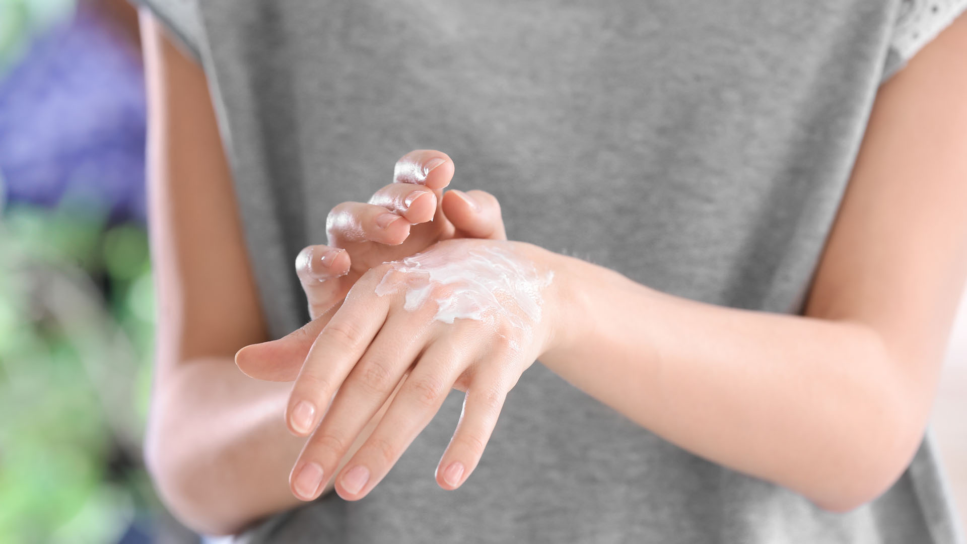 A person is applying lotion to their hands.
